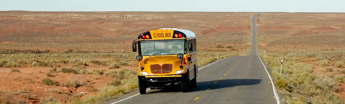 School bus on road in desert