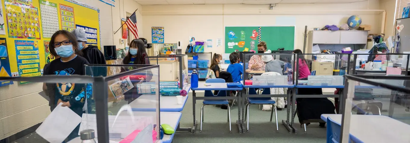 Classroom with students and teacher at work 